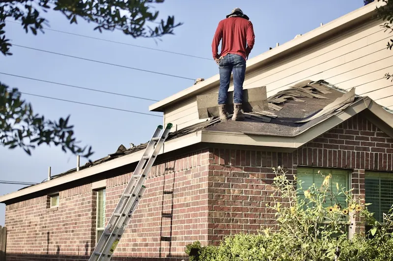 Professional roofer working on a residential roof in Battle Creek